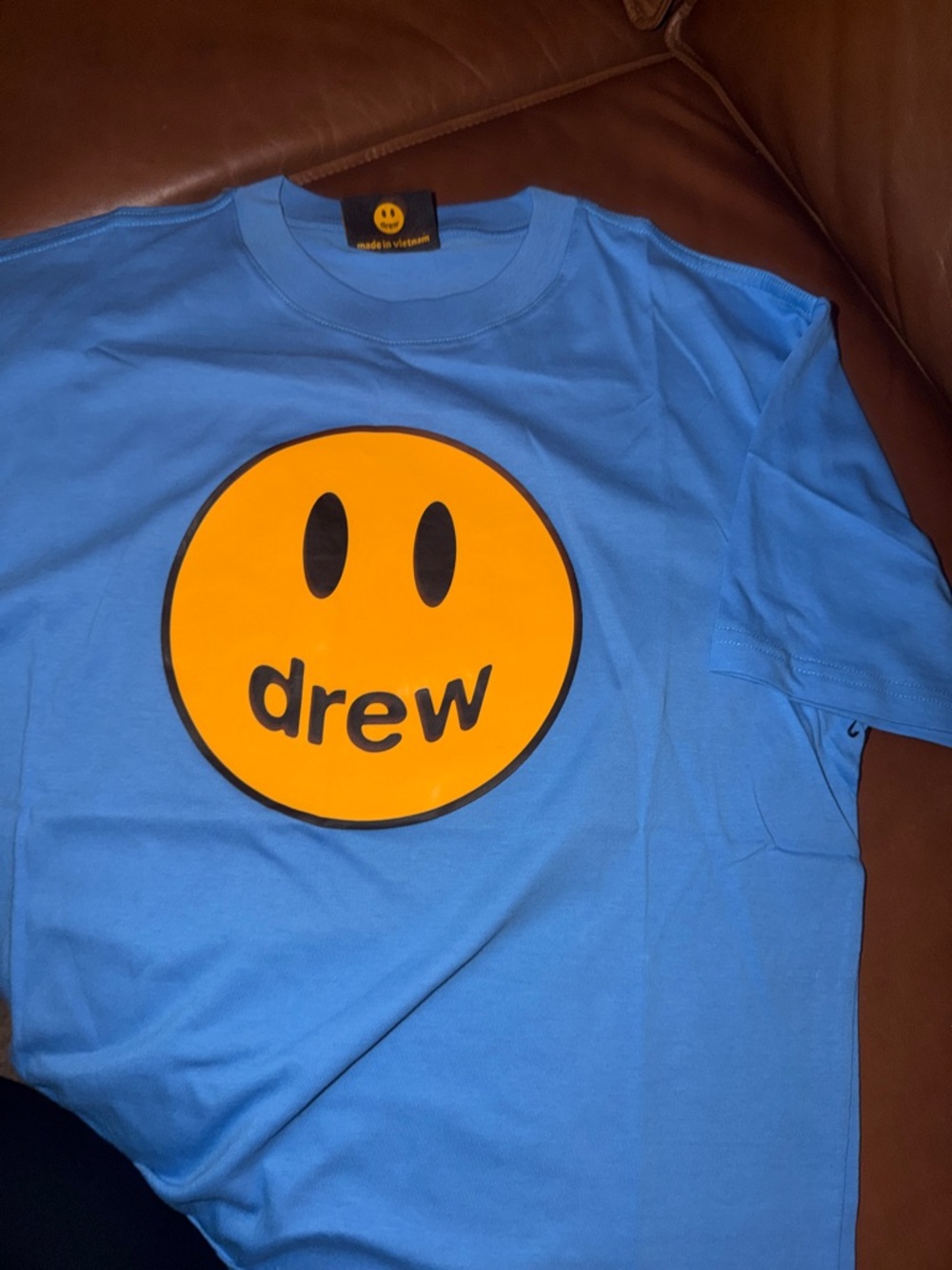 drew house Light Blue Tee with Orange Smiley Graphic